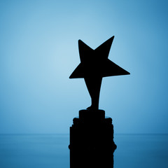 Wall Mural - star trophy silhouette, blue background