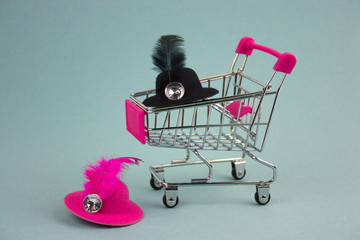 shopping cart with pink and black hats