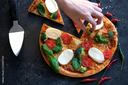 Fotografie, Obraz Sliced pizza with Mozzarella cheese, tomatoes, broccoli, Spices and fresh basil