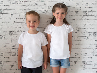 t-shirt design concept - smiling happy children in white blank t shirt