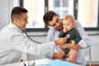 © Syda Productions - medicine, healthcare, pediatry and people concept - father with baby and doctor with stethoscope at medical office in hospital