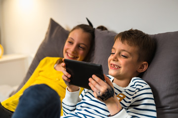 kids playing games on tablet at home