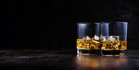 whiskey with ice in modern glasses