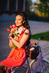 Wall Mural - Latin woman in pink dress with flowers and pink bicycle.