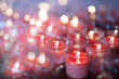 Many red candles in clear glass With bokeh on the back.soft focus.
