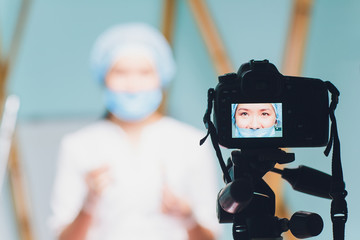 cheerful beautiful woman doctor recording vlog video about medicine and health care.