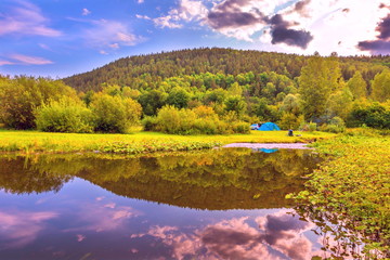 Picturesque parking on the river bank. The nature of the Urals.