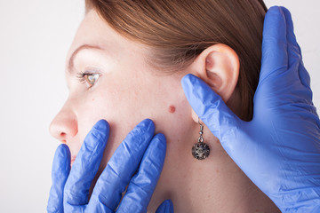 Oncologist examining female patient in clinic. Cancer awareness