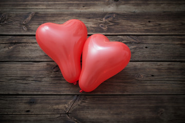 heart shaped red  balloons on  wooden background