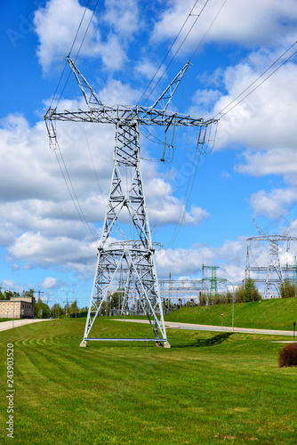 Fotografía High-voltage tower on green grass and sky in background. - Image