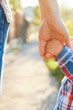 © Kostia - the parent holding the child's hand with a happy background