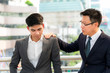 Asia Business men are discouraged But there is co-worker on the shoulders encouraging advice for the success of the work done together, to counsel concept.