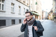 © bnenin - Handsome man talking on the mobile while walking. Winter time. Wearing coat.