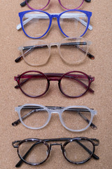 Sticker - Different eyeglass frames on cork board