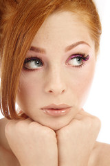 Close-up portrait of young beautiful redhead girl with freckles