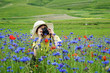 Young photographer in the field of flowers