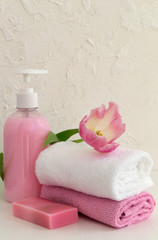 Liquid soap and two towels on a white background.