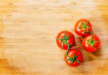 Truss Tomatoes On Wooden Background