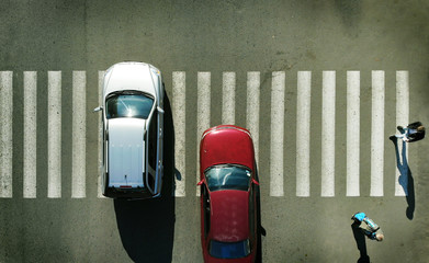 Aerial. Two cars on a pedestrian crossing. 