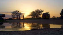 African Road Reflection With People At Sunset