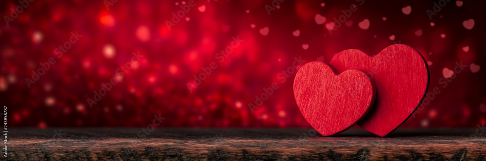 Two Red Valentine's Hearts Standing On Wooden Table With Soft Romantic background - obrazy, fototapety, plakaty 