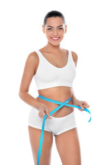 Poster - Slim woman measuring her waist on white background. Weight loss