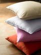 © lichaoshu - Closeup multi-coloured pillows on wooden background