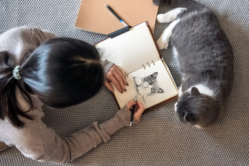 Canvas Print - Women and cats are lying on the ground painting.