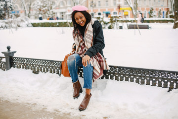 Elegant black girl in a winter city