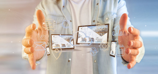 Poster - Businessman holding a Devices connected to a cloud multimedia network 3d rendering