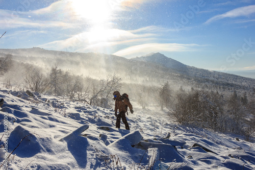 Winter hiking in the mountains on a sunny windy day Poster Mural XXL