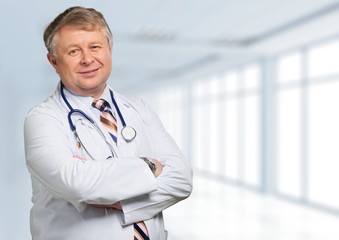 Canvas Print - Portrait of  doctor  with arms crossed in medical office