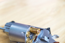.357 .44 Magnum Revolver Gun With Bullet On Wood Background