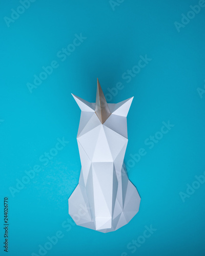 White 3d Papercraft Model Of Unicorn Head On Blue Background