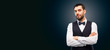 people concept - serious man in white shirt, waistcoat and bowtie over black background