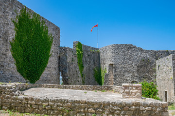 Wall Mural - Medieval stone fortress is located high in the mountains.