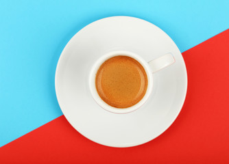 Wall Mural - Full white espresso coffee cup on red and blue