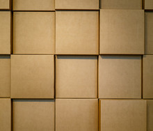 Cardboard Boxes Stacked In A Wall. Background