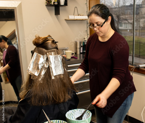 Professional Millennial Hair Stylist Applying Hair Color Foils To