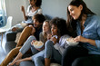 © Westend61 - Friends sitting on couch watching tv