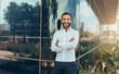 © JonoErasmus - Portrait of a young confident smiling indian man with his arms crossed looking into the camera