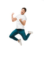 Excited Young Man Jumping And Smiling At Camera Isolated On White