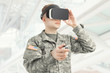 Indoors shot of USA soldier wearing VR glasses