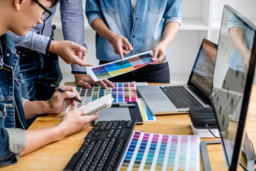 Poster - Team of young colleagues creative graphic designer working on color selection and drawing on graphics tablet at workplace, Color swatch samples chart for selection coloring