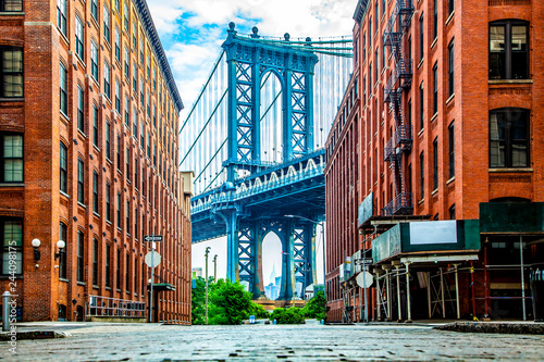manhattan-bridge-between-manhattan-and-brooklyn-over-east-river-seen-from-a-narrow-alley-enclosed-by-two-brick-buildings-on-a-sunny-day-in-washington-street-in-dumbo-brooklyn-nyc