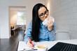 © mnelen.com - busy business woman working hard at a cafe, eating a sandwich and coffee