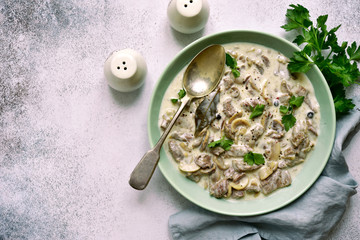 Wall Mural - Beef stroganoff - meat stewed in cream sauce with mushrooms.Top view with copy space.