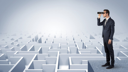 Wall Mural - businessman standing on maze and looking forward to the future concept