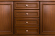 Front showcase cabinet or wardrobe wooden frame door and drawers made from dark wood, background and texture.
