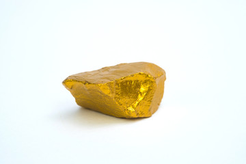 Closeup of gold nugget or gold ore on white background, precious stone or lump of golden stone, financial and business concept.